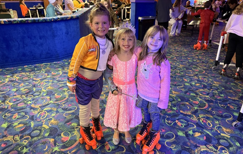 Students wearing costumes at skate night