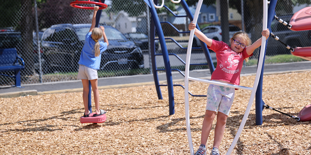 Two children play on a playground.