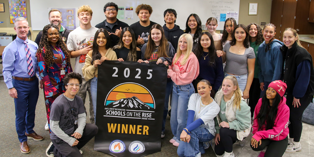 Rogers students with school on the rise winner banner