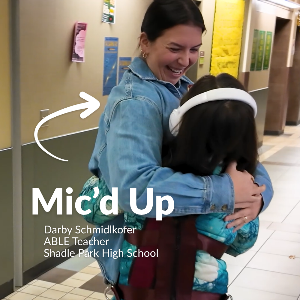 Shadle Park High School ABLE teacher Darby Schmidlkofer hugs a student in a video titled "Mic'd Up"