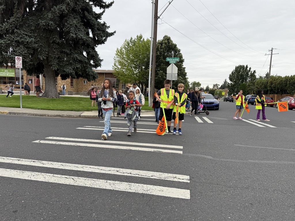 Student crossing guards helping students cross the street safely.