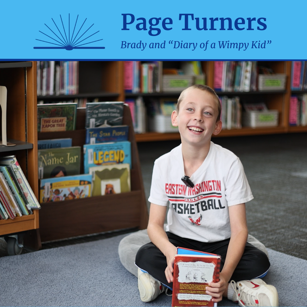 A boy smiles while holding a book in a library with the text "Page Turners: Brady and "Diary of  a Wimpy Kid"