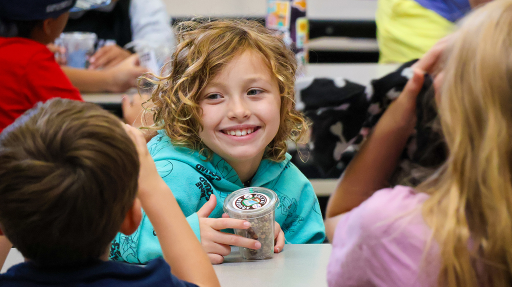 Kid smiling at table