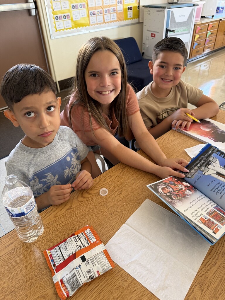5th grade student reading with 1st grade buddies.