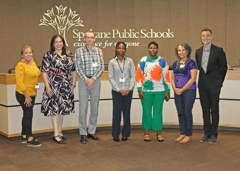 A student poses with the Spokane Public Schools Board of Directors.