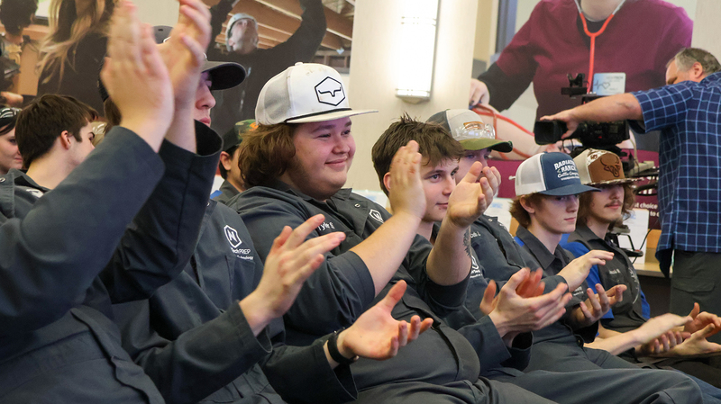 NEWTech Prep student applaud as they watch a presentation of a $50,000 donation for their program. 