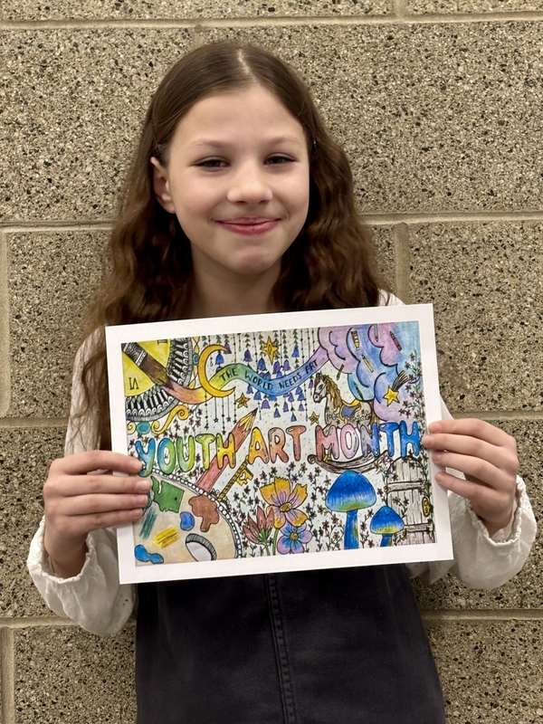 A middle school holds a colorful drawing incorporating the text “The World Needs Art” and “Youth Art Month” into a design with painting materials, clouds, flowers, mushrooms, a rocking horse and a rustic wooden door with a skeleton key.