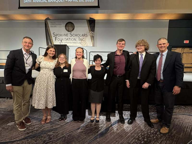 Six Spokane Scholars from Ferris High School smile with Principal John O'Dell and Superintendent Adam Swinyard.