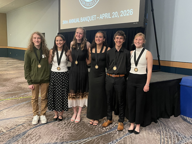 Six Spokane Scholars from North Central High School smile while wearing medals.