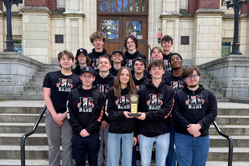 Lewis and Clark percussion students post with a first place trophy.
