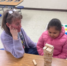 Mrs. Handley playing Jenga with a student