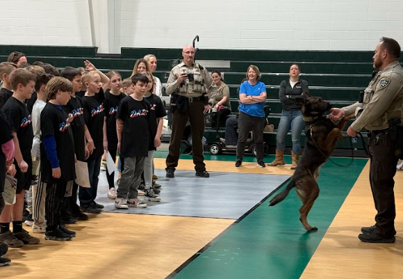 Deputy Burgess, Deputy Davis, and Hondo with the DARE graduates
