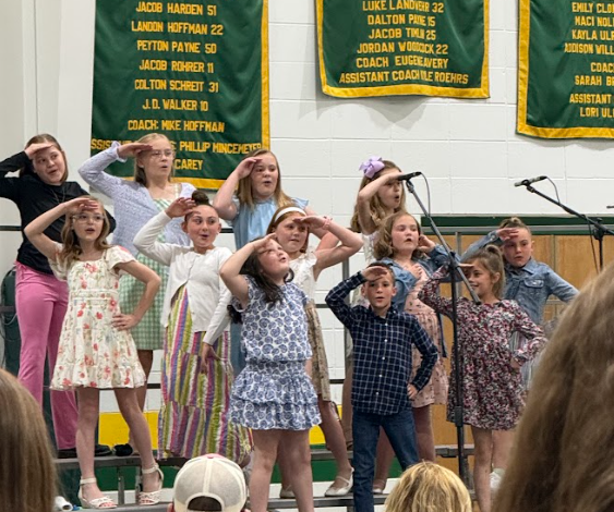Students on a stage singing