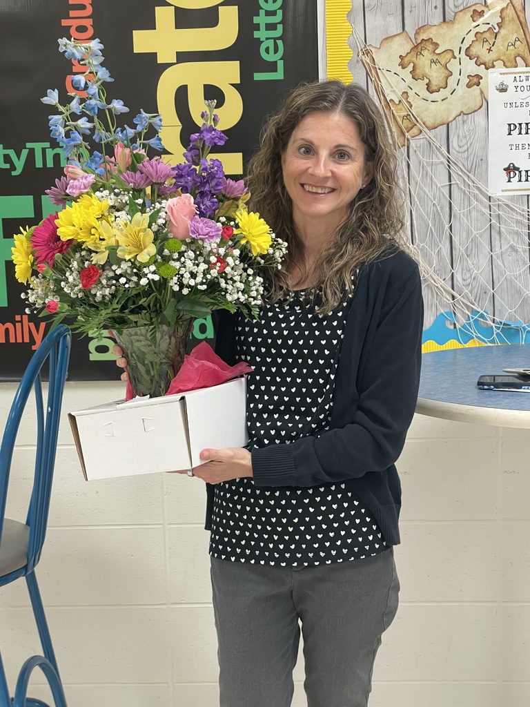 Picture of Jill Wagner with flowers. Her last day as School Board President