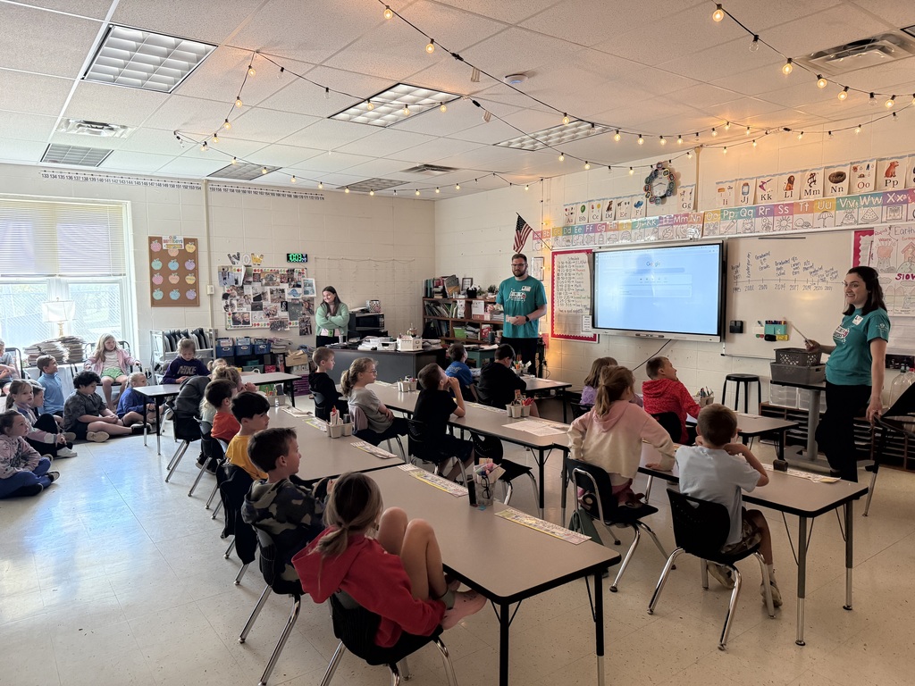 2nd graders listening to a presentation on money management and savings