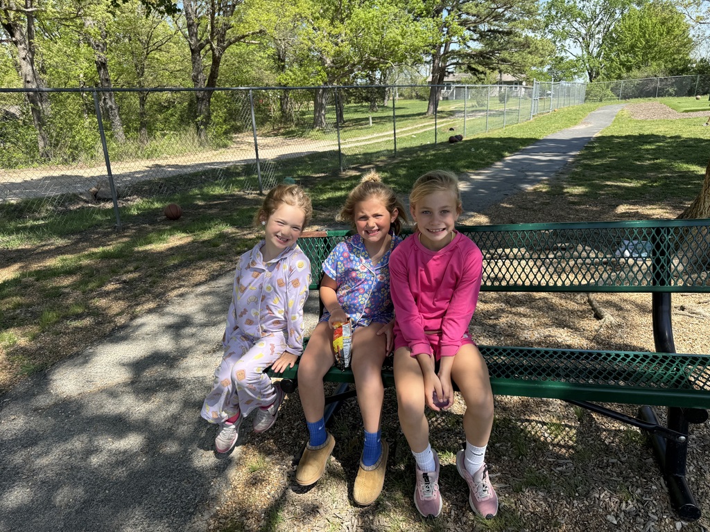 Students on a bench in pajamas for spirit week