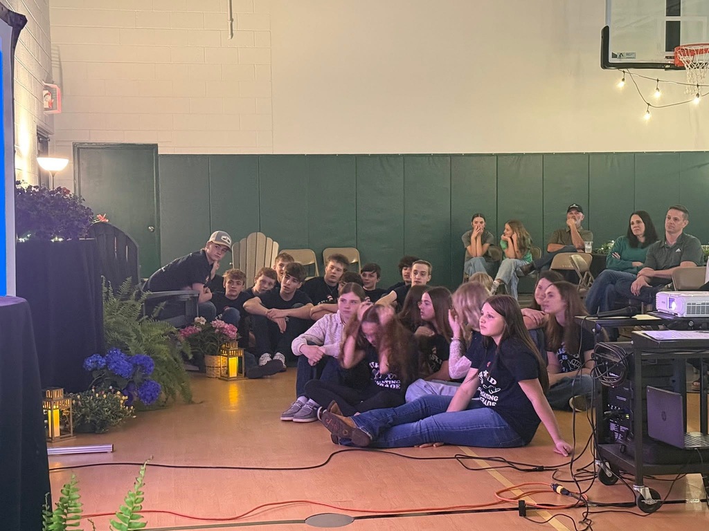 Students watching a video at 8th grade banquet