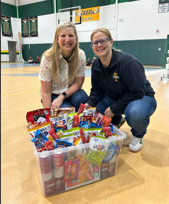 Staff with a tote of goodies for staff appreciation