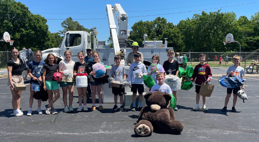 students standing in front of a boom truck getting ready for the egg drop challenge