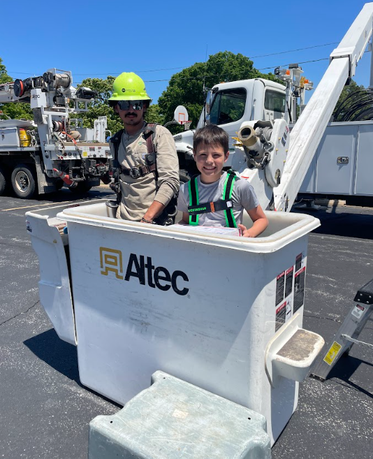 a student going up in a boom truck for the egg drop challenge