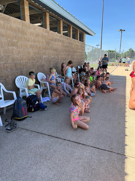 students sitting at the pool