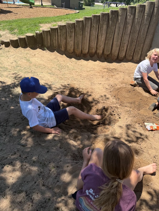 students playing in the sand