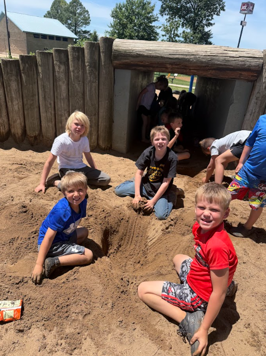 students playing in the sand