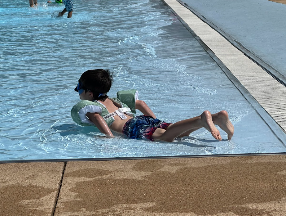 student playing at the pool