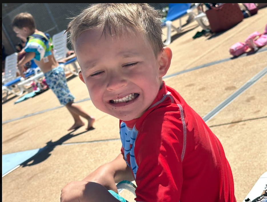 student smiling at the pool