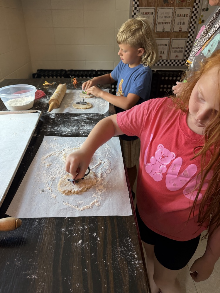 students making cookie dinosaur fossils 