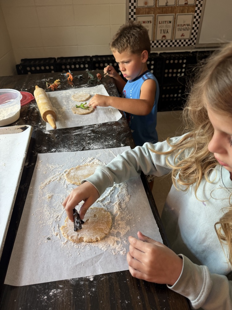 students making cookie dinosaur fossils 