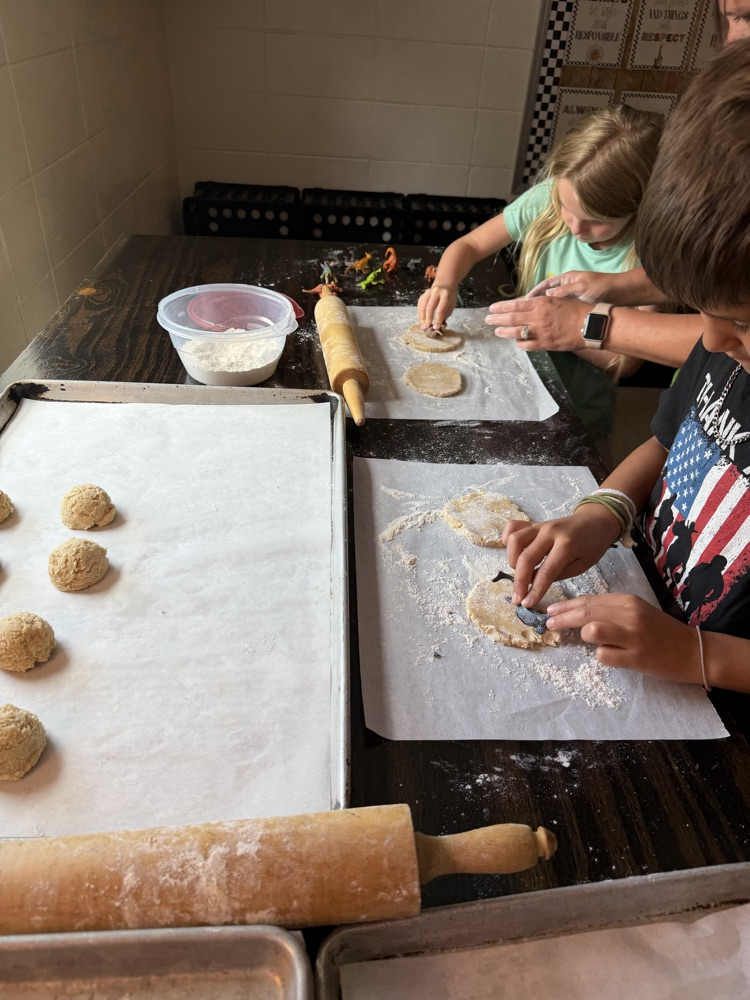 students making cookie dinosaur fossils 