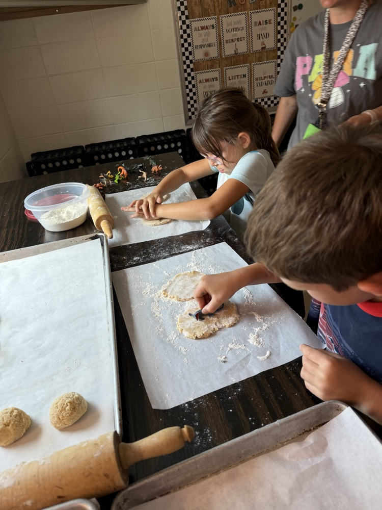students making cookie dinosaur fossils 