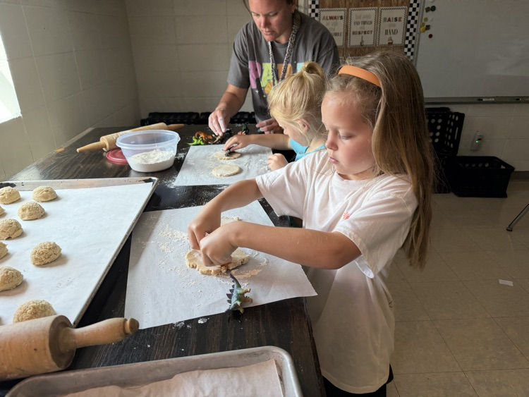 students making cookie dinosaur fossils 