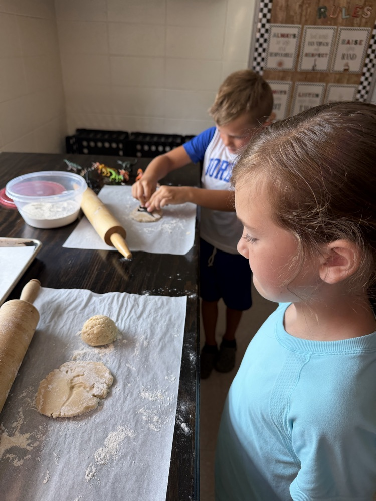 students making cookie dinosaur fossils 