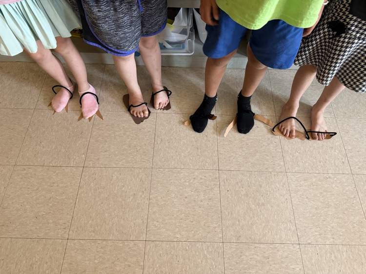 students made dinosaur feet