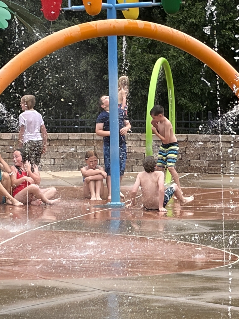 Students playing at the splash pad