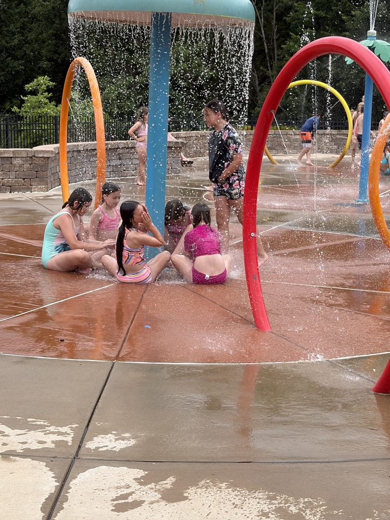 students playing at the splash park
