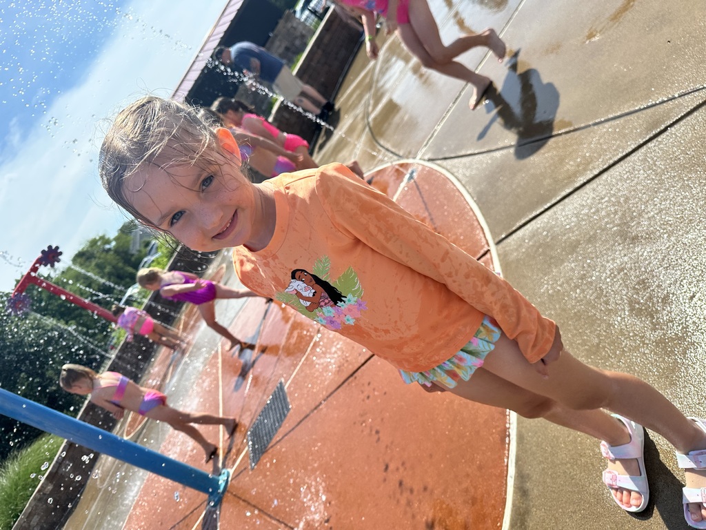 student playing at the splash pad