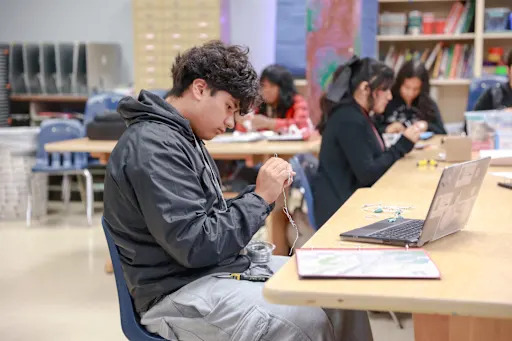 student making art out of metal wire