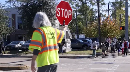 crossing guard holding stop sign