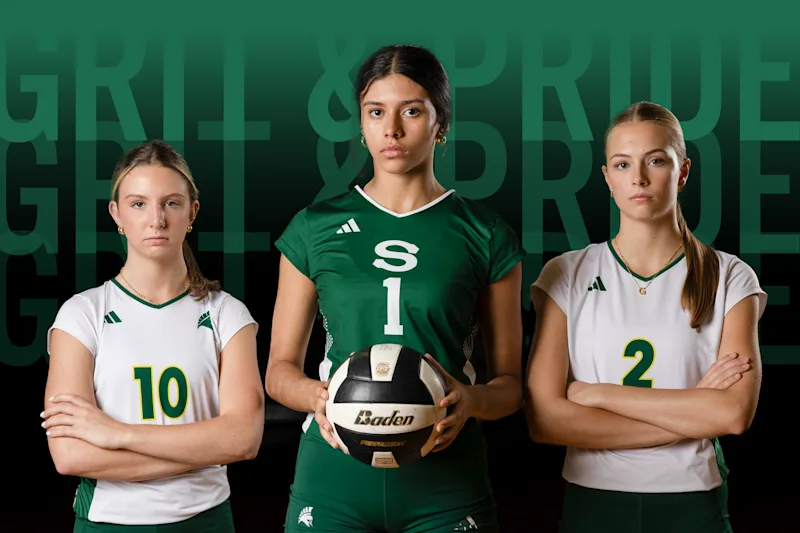 Stratford High School Women's Volleyball team standing in front of text reading "grit & pride"