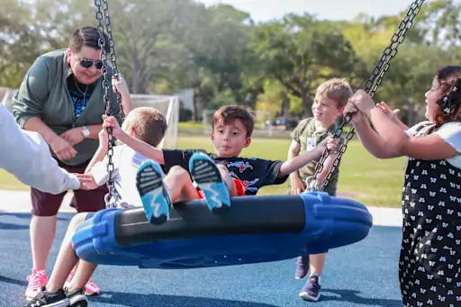 child swinging on large swing