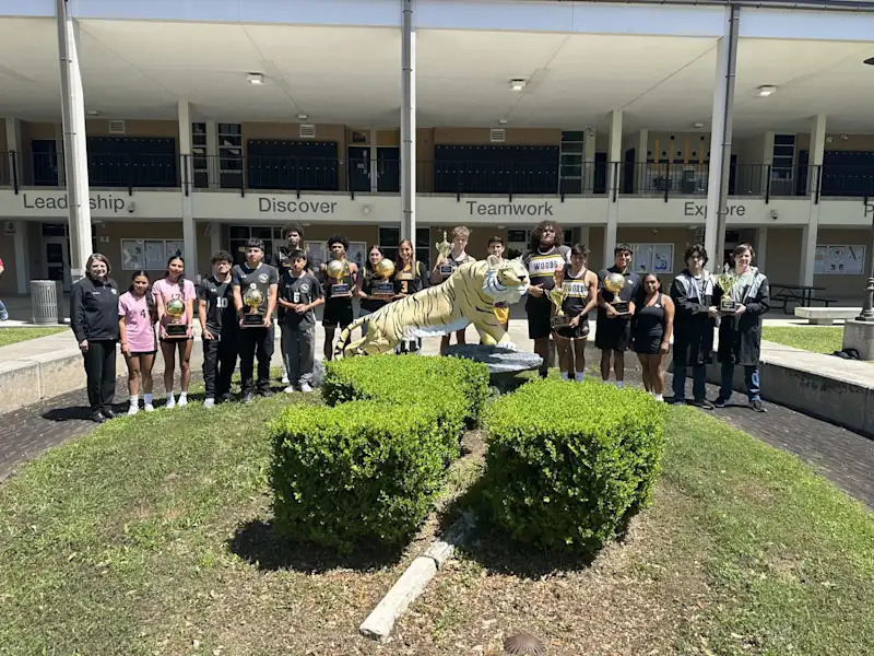 Various Spring Woods sports teams displaying their trophies from the year