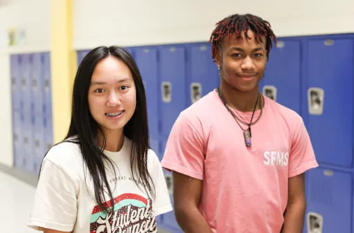 two students standing in front of lockers