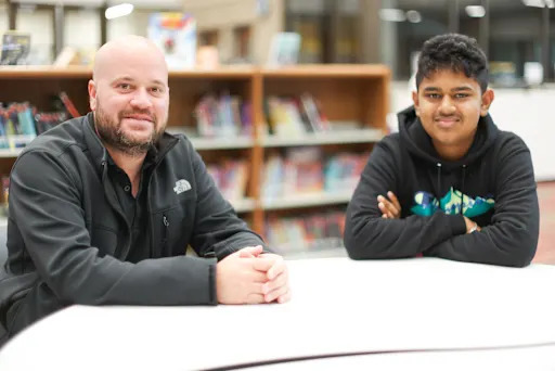 Cason Sicking sits with a student