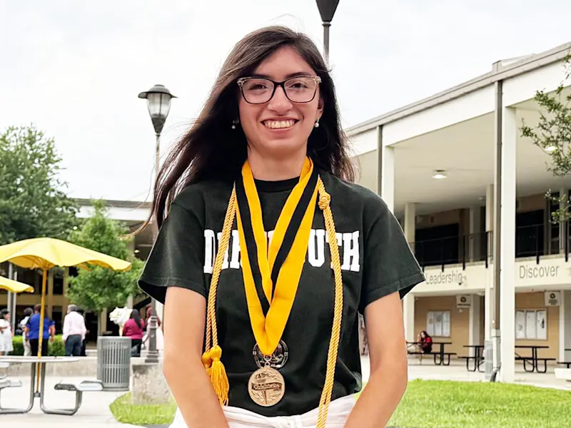 Hanna Araiza Rojas smiling wearing graduation chords and a medal