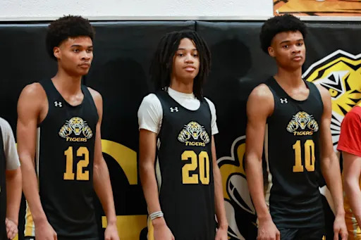Tavionn, Trae, and Torian Pickens standign together on the basketball court