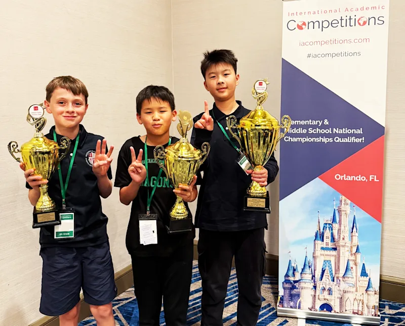 Students holding trophies earned in the National History Bee