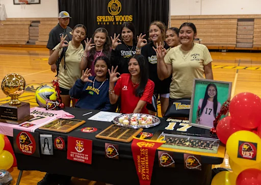 Sprign Woods students gathered around a college commitment table